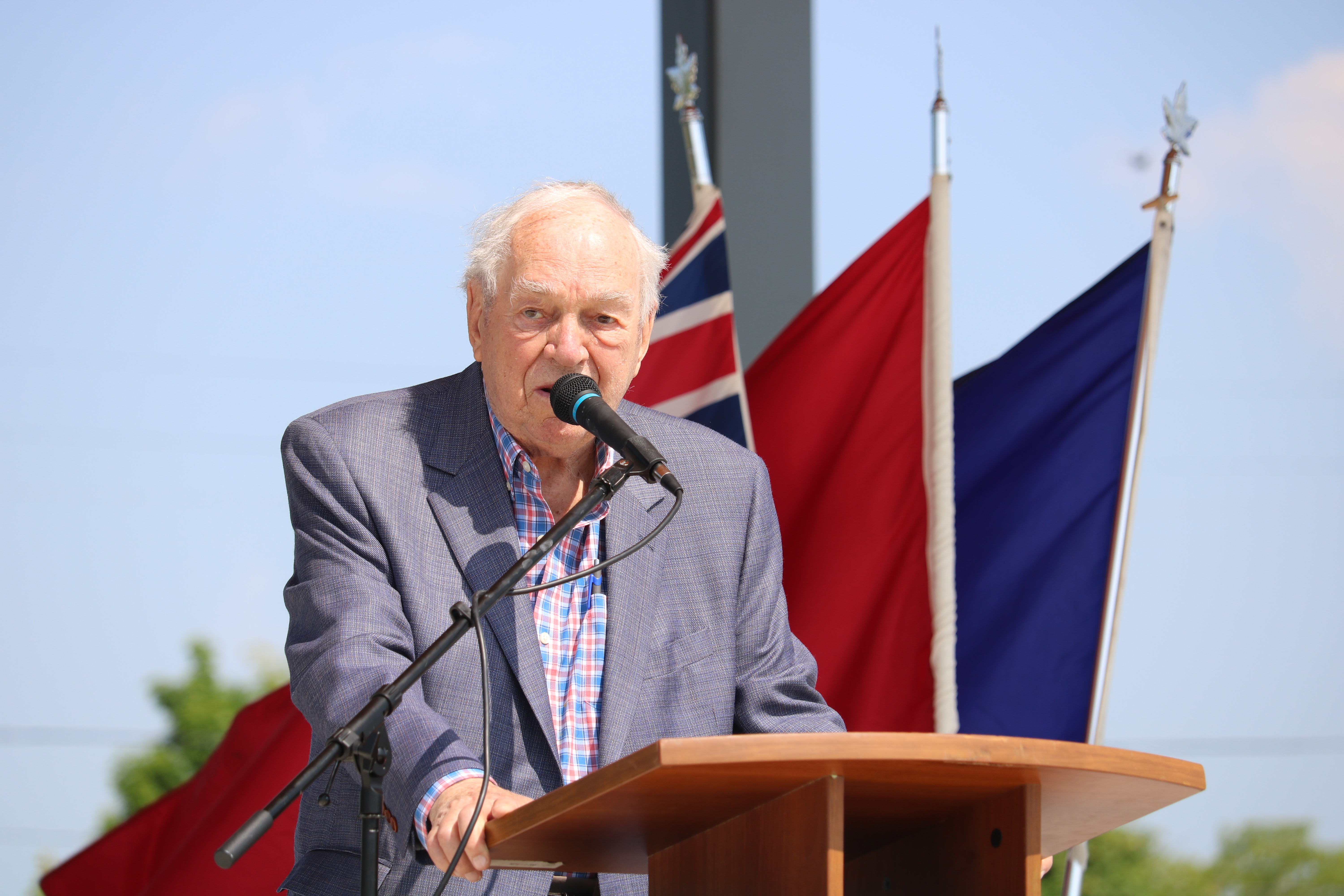 Ed Broadbent talking at a podium.