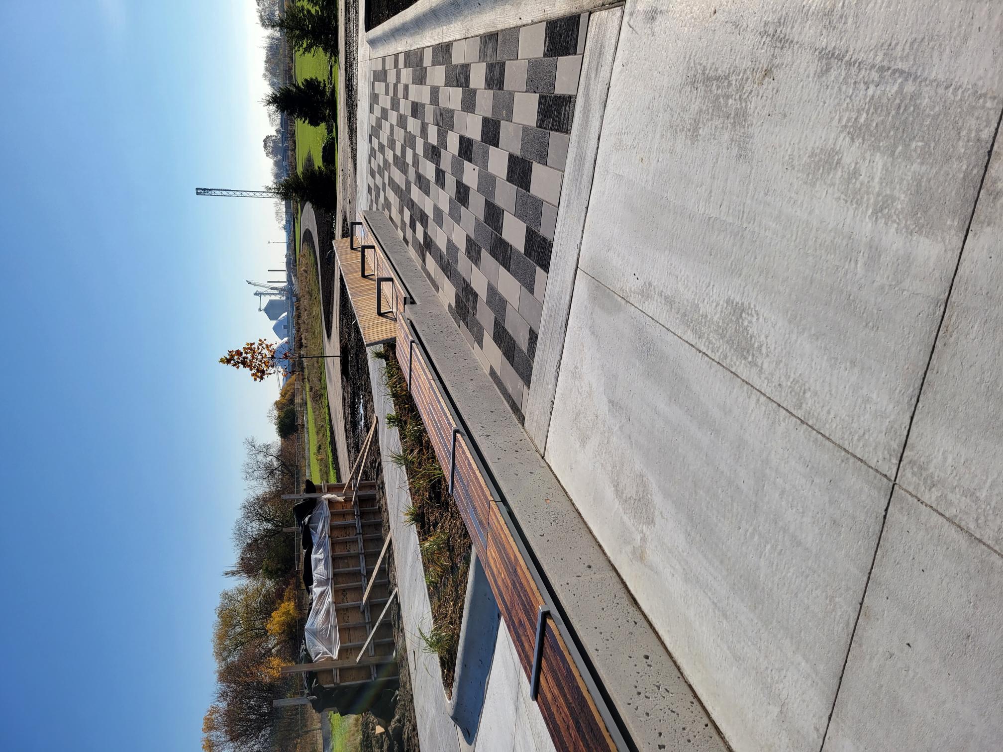A section of the Garden of Human Rights with a long bench going across with half of it having a backrest.